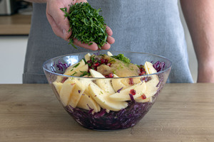 Petersilie an den Salat geben