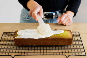 Frosting auf Pistazienkuchen streichen