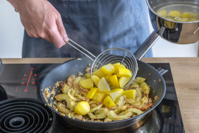 Kartoffeln zum Gurkengemüse geben