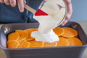 Schmand über Kürbislasagne geben