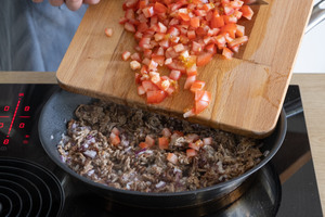 Tomaten zum Hackfleisch geben