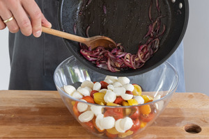 Zwiebeln zum Tomatensalat geben
