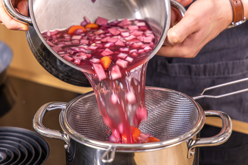 Gemüse durch ein Sieb abgießen