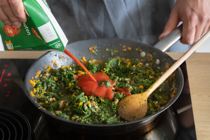Passierte Tomaten zum restlichen Gemüse geben