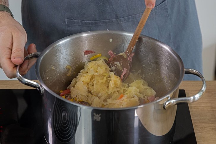Sauerkraut in den Topf geben