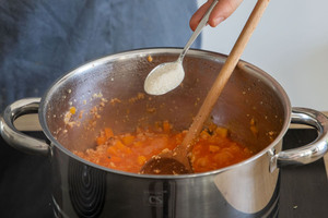 Zucker in die vegane Kürbis-Bolognese mit Sojaschnetzel geben