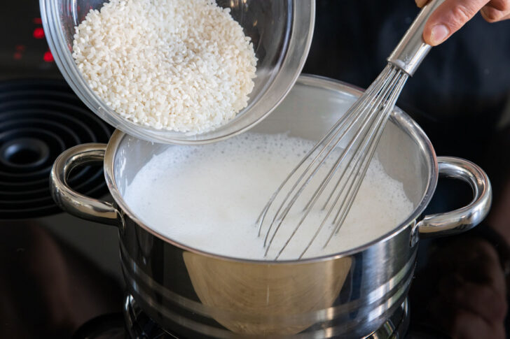 Milchreis in Milch rühren
