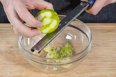 Knoblauch und Limettenschale reiben
