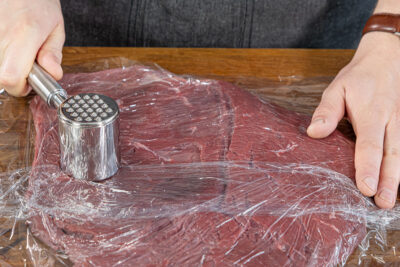 Fleisch mit Fleischklopfer plattieren