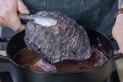 Sauerbraten aus dem Backofen nehmen und in Scheiben schneiden