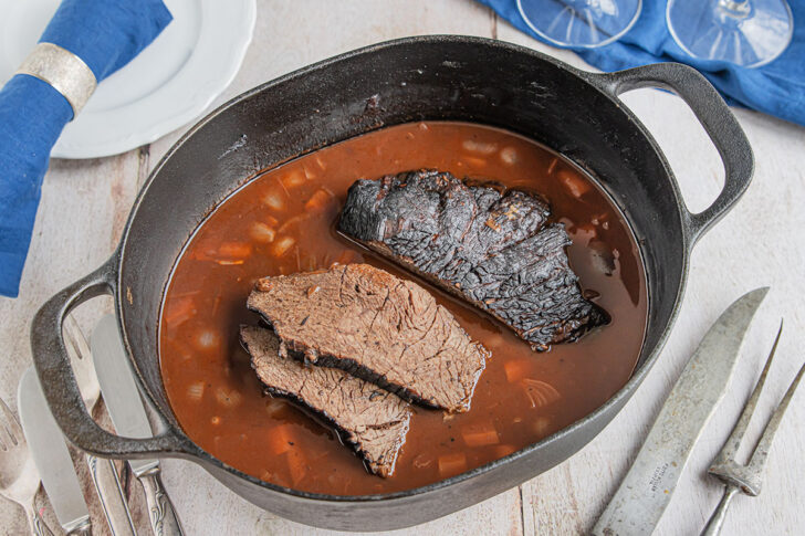 Sauerbraten aus dem Backofen mit Sauce servieren