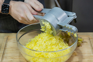 Kartoffeln durch Kartoffelpresse pressen