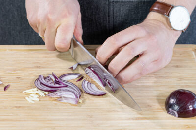 Knoblauch und Zwiebeln in Streifen schneiden