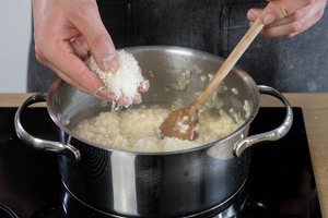 Parmesan zum Risotto mit Milchreis dazugeben.