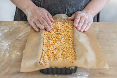 Backerbsen auf den Teig geben und den Boden für die Rhabarbertarte backen