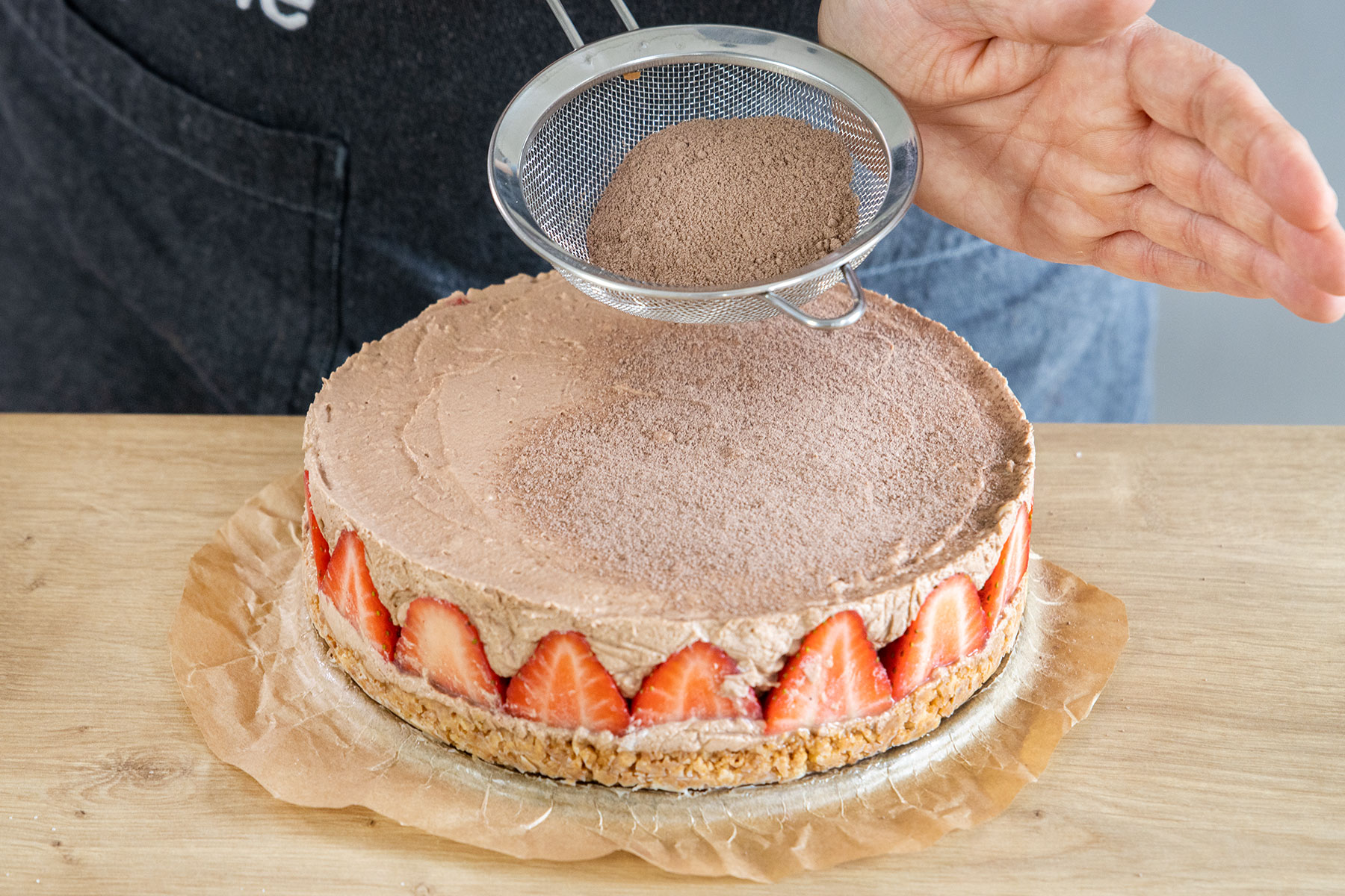 Erdbeer Schoko Mousse-Torte mit Kakao bestäuben