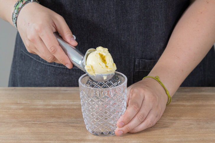 Eis in ein Glas geben