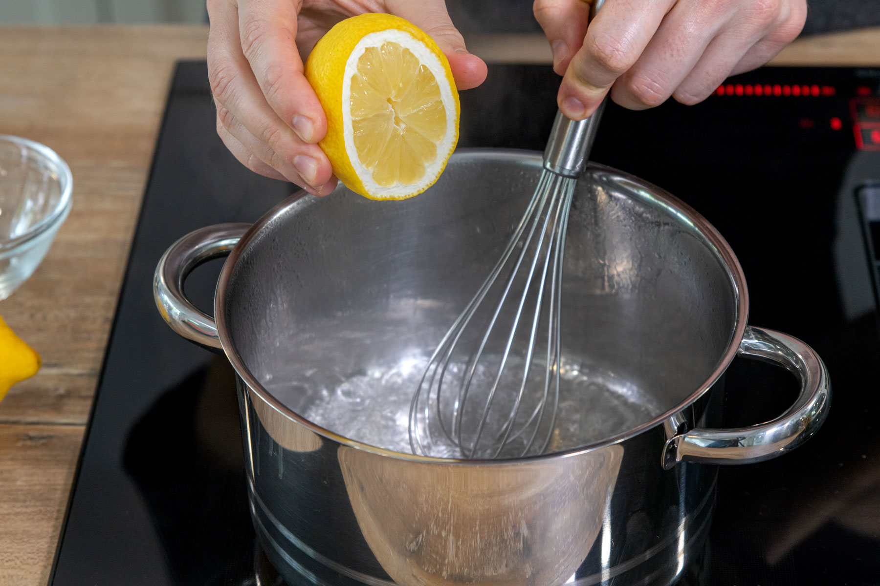 Zitronensaft zum Läuterzucker geben