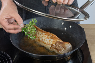 Kräuter zum Filet geben und abgedeckt weiter braten