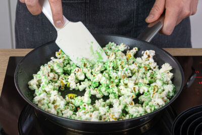 Popcorn im grünen Karamell wenden