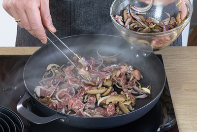 mariniertes Fleisch mit Pilzen anbraten