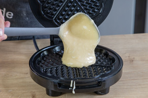 Waffelteig in Waffeleisen geben