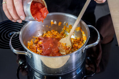 gehackte Tomaten in den Topf geben