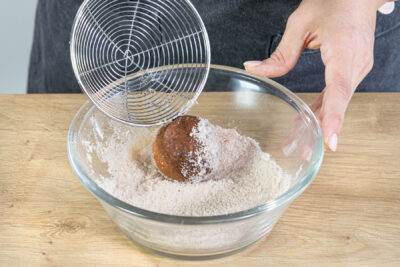 Quarkbällchen in Zucker und Zimt wälzen