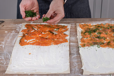 Räucherlachs und Dill auf dem Blätterteig verteilen
