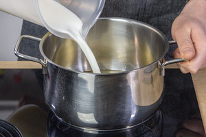 Milch in den Topf gießen