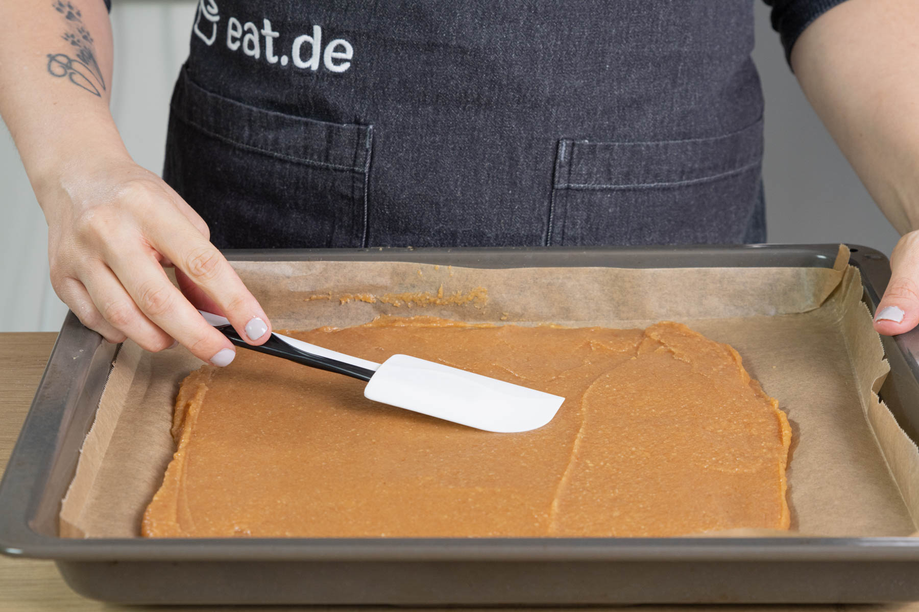 Masse für das Quittenbrot auf einem Blech verstreichen