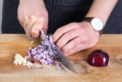 Knoblauch und Zwiebeln würfeln