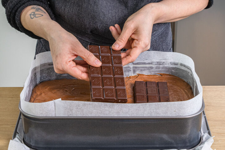 Schokolade in den Teig für Schoko-Brownie mit flüssigem Kern geben