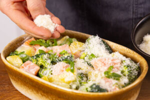 Lachs-Brokkoli-Auflauf mit Parmesan bestreuen und backen