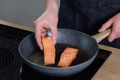 Lachs in die Pfanne legen