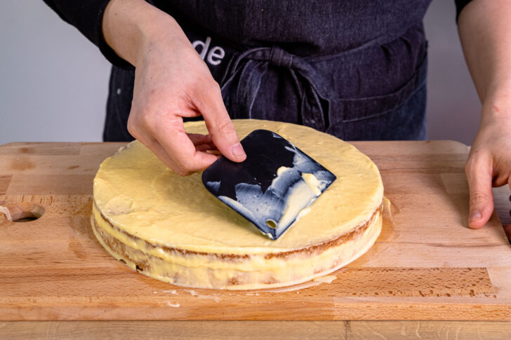 Pudding auf dem zweiten Mandeltorten Boden verstreichen