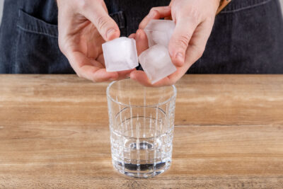 Eiswürfel in das Glas geben