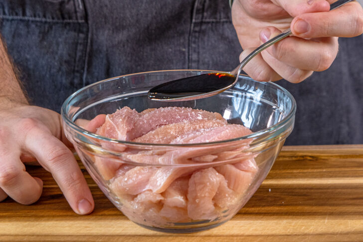 Sojasauce zum Fleisch geben