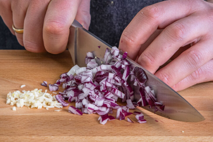 Zwiebel und Knoblauch würfeln