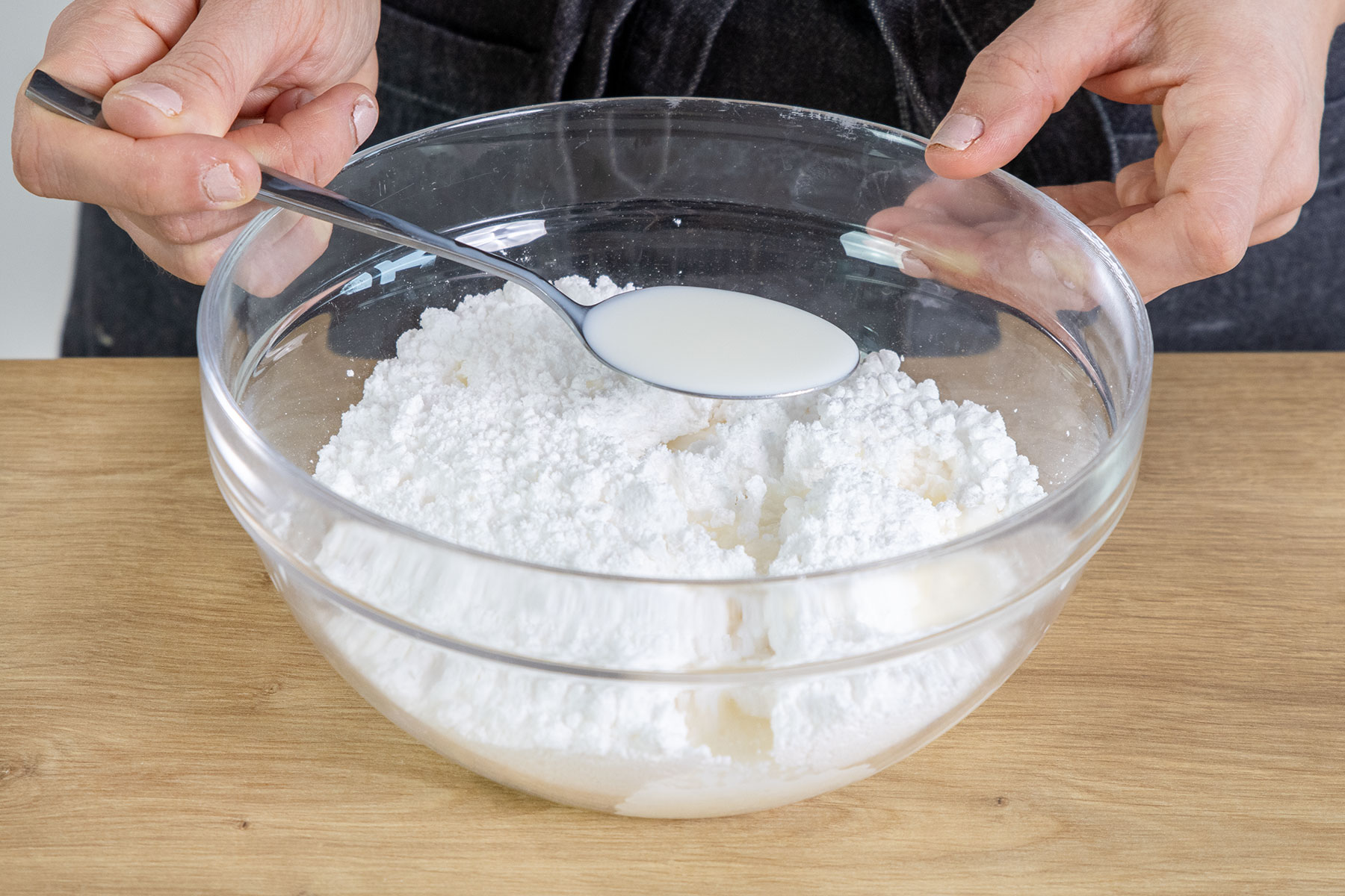 Milch zum Puderzucker geben