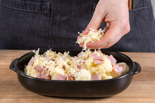 Blumenkohlauflauf mit Käse bestreuen