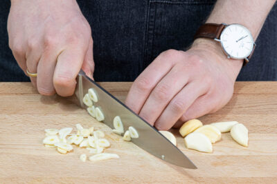 Knoblauch in feine Scheiben schneiden