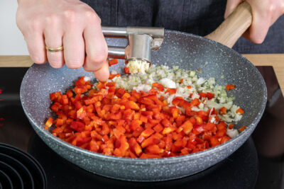 Knoblauch zur Paprika pressen