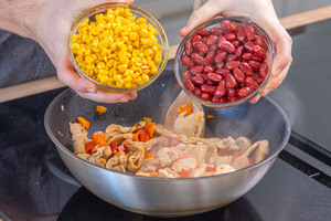 Bohnen und Mais zum Fleisch geben