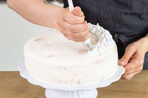 Baisermasse auf Zitronencreme-Torte spritzen