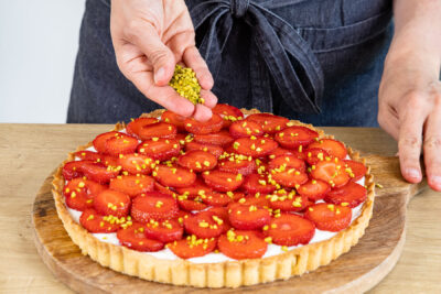 Pistazien über Erdbeeren streuen