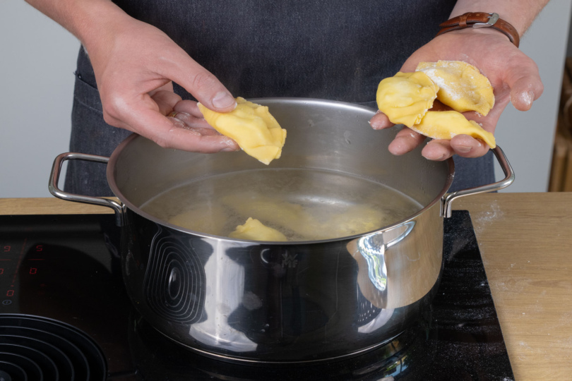 Die Kartoffel-Quark-Pierogi in das heiße Wasser geben.