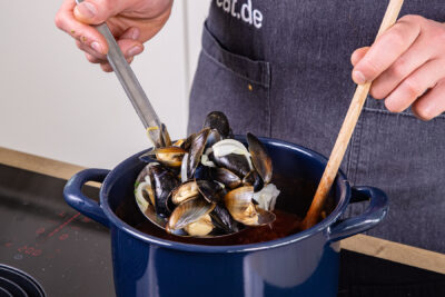 Miesmuscheln in Tomatensauce vermengen