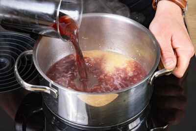mit Rotwein und Brühe ablöschen