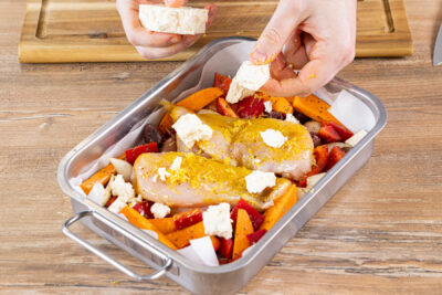 Feta über das Zitronenhähnchen vom Blech bröseln